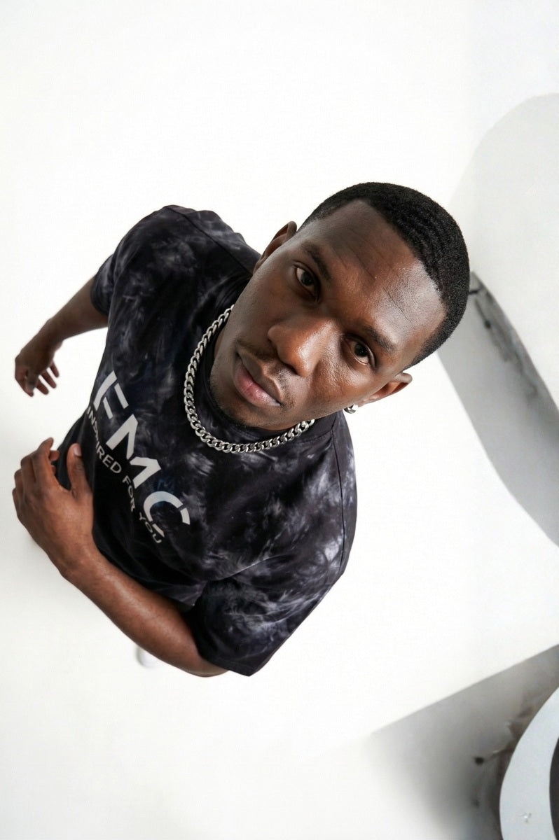 Man wearing a black t-shirt with 'FMC' logo and text on a white background