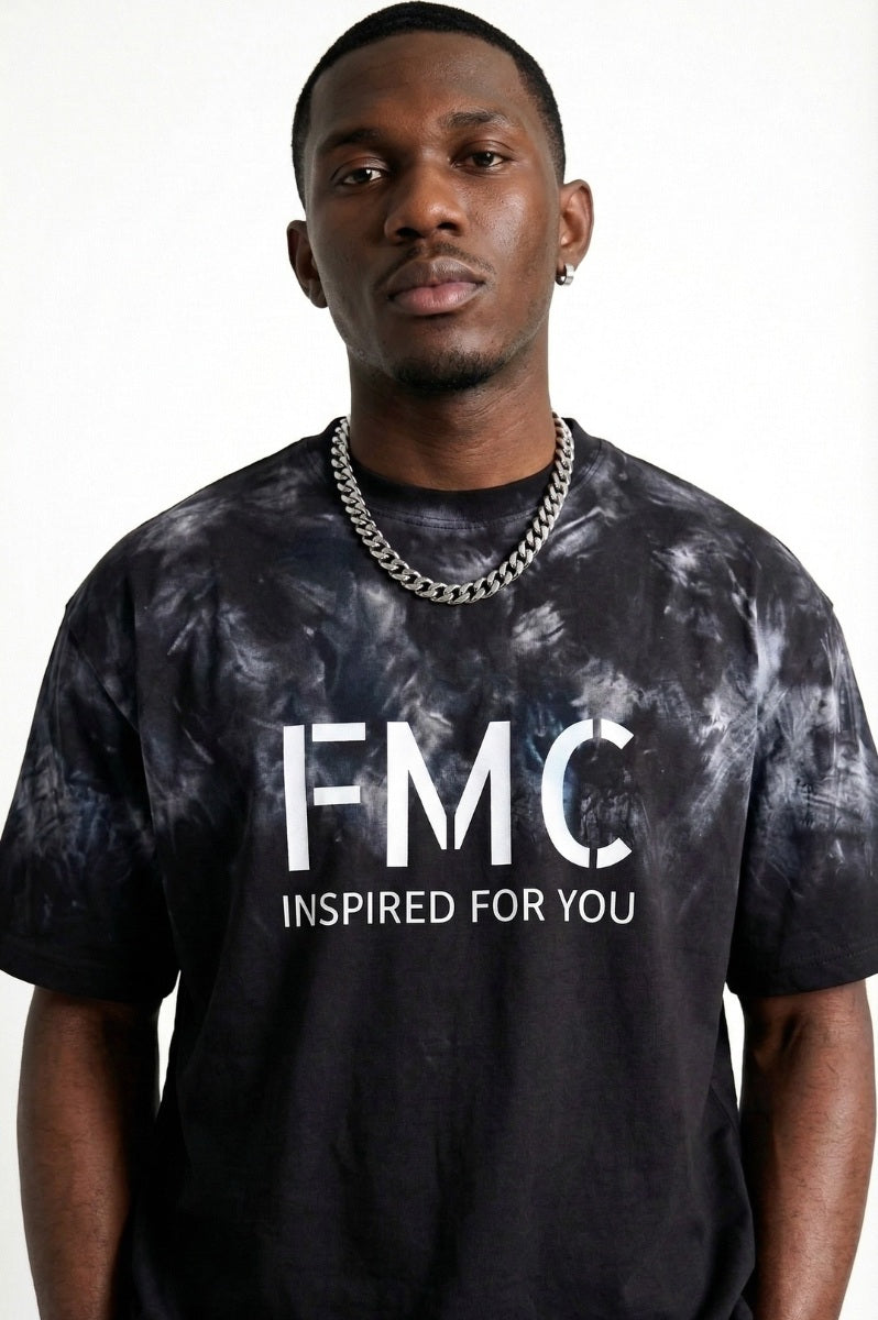 Man wearing a black t-shirt with 'FMC' logo and text on a white background
