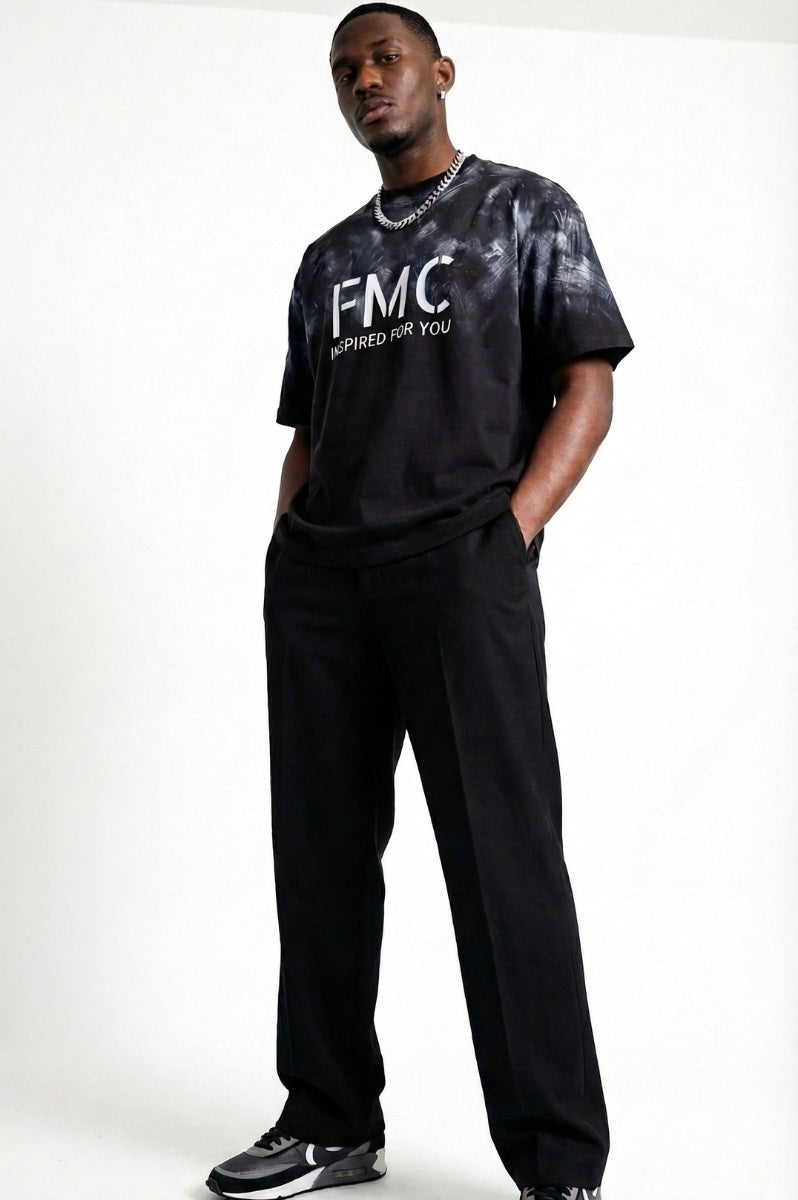 Man wearing a black t-shirt with 'FMC' logo and text on a white background