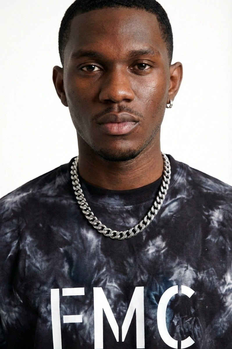 Man wearing a black t-shirt with 'FMC' logo and text on a white background